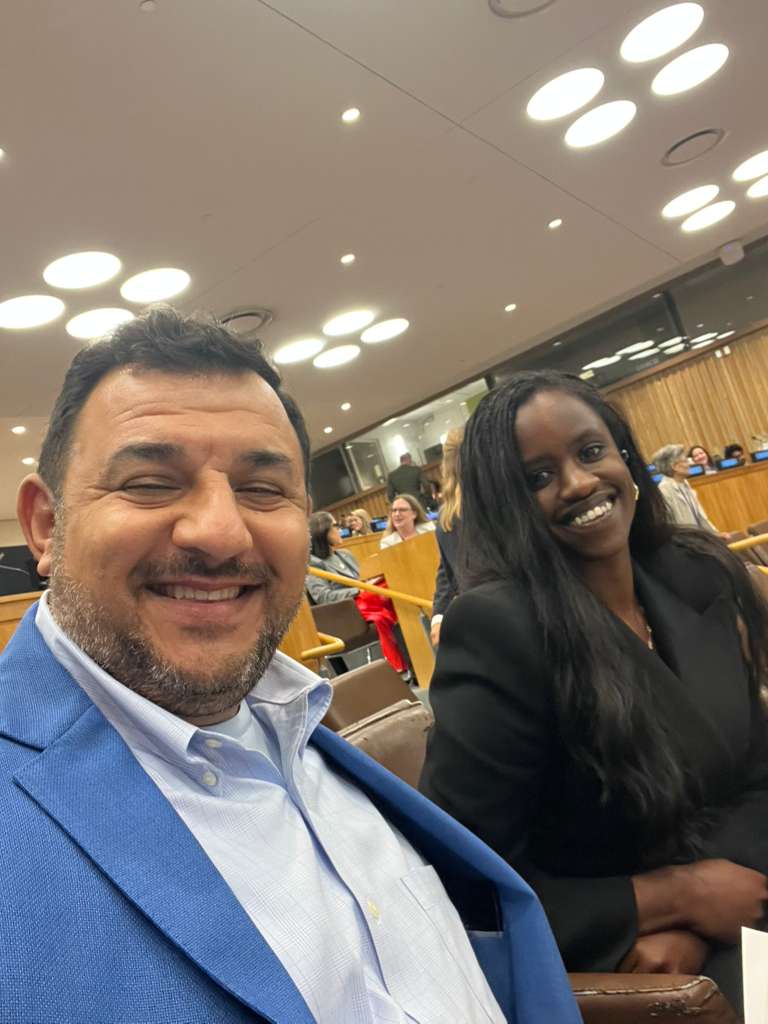 Humam Rajab with a civil society partner in the conference hall